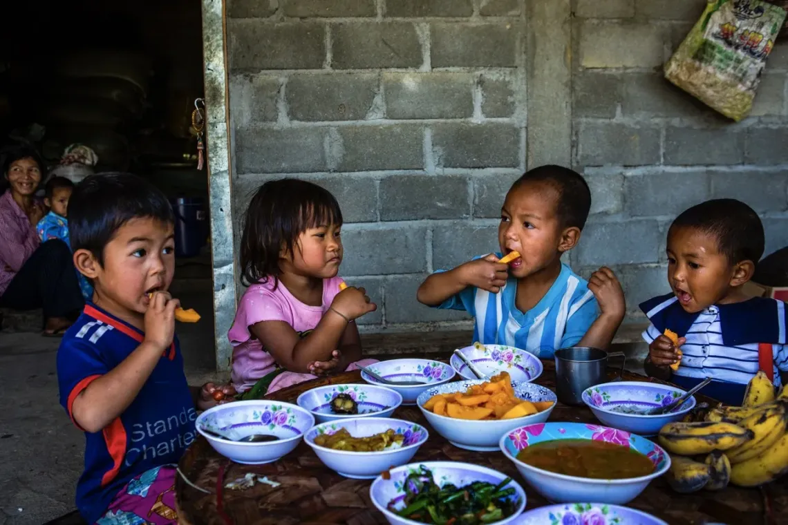 Children from the village enjoy &nbsp;their nutritious meal prepared by Daw Buu Shane. Tin Htet village, Keng Tung township, eastern Shan state of Myanmar.